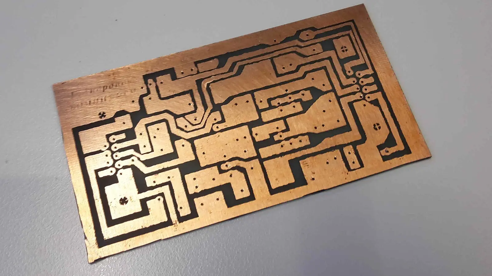 After removing the protective layer from the manually etched circuit board, the plain copper surface is appearing.